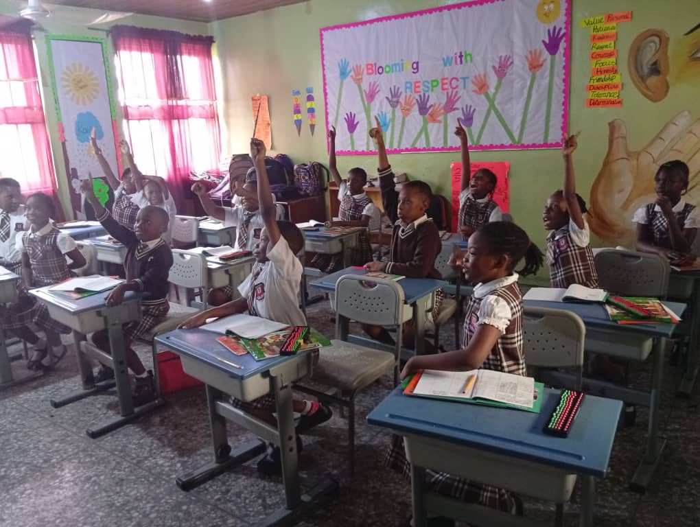 Nigerian primary school students in abacus class actively participating with raised hands