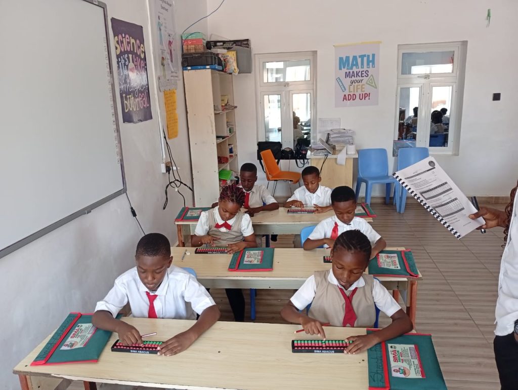 Nigerian child concentrating on abacus training in class